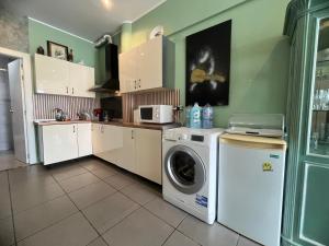 a kitchen with a washing machine and a washer at Local 3 Puerto Colon First Line The Loft Coworking Suite in Adeje