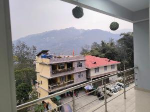 a view of a building with a mountain in the background at Natures Life urban homestay in Gangtok