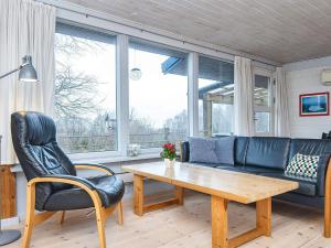 a living room with a couch and a table at 6 person holiday home in Glesborg in Bønnerup