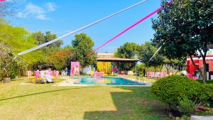 a pool with a party set up in a yard at Red orchid farm in Gurgaon
