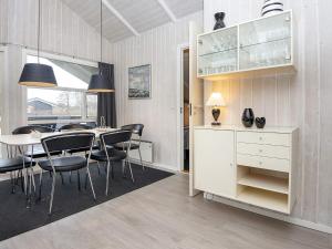 a dining room with a table and chairs at 6 person holiday home in Hemmet in Falen