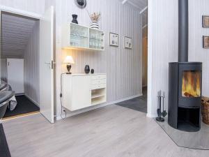 a living room with a fireplace and a fire place at 6 person holiday home in Hemmet in Falen