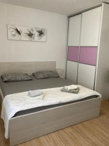 a bedroom with a bed with two towels on it at Studio Apartment 3e in Split