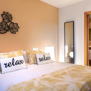 a bedroom with a bed with two pillows on it at Apartamentos Naredo in Villaviciosa