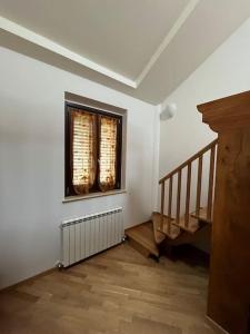 an empty room with a staircase and a window at Casa “il riposo del pescatore” in Porto San Giorgio