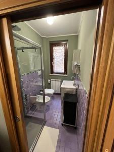 a bathroom with a shower and a toilet and a sink at Casa “il riposo del pescatore” in Porto San Giorgio
