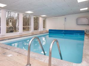 a swimming pool in a building with windows at 6 person holiday home in Hemmet in Hemmet