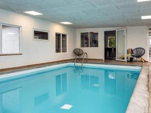 a swimming pool with blue water in a room at 6 person holiday home in Hemmet in Hemmet
