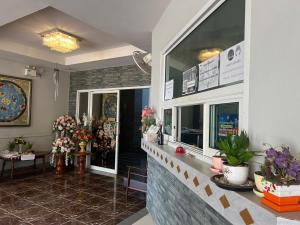 a lobby with a flower shop with potted plants at Pilatus Apartment in Loei