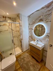 a bathroom with a sink and a toilet and a mirror at MIA HOME MARBELLA in Marbella +16 photos