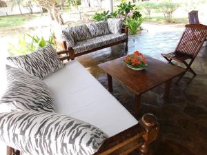 a living room with a zebra couch and a table at Holiday home in Malindi in Mambrui