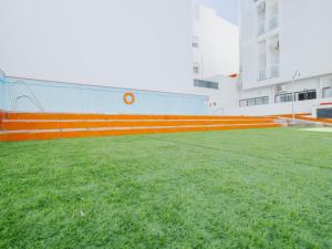 a large field of grass in front of a building at Apartamento Terraza a la Almadraba in Barbate
