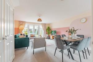 a living room with a dining room table and chairs at Stylish & Spacious 3bed Home with Fast Wifi & Private Parking in Cambourne