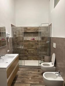 a bathroom with a shower and a toilet and a sink at Bari Holiday Garibaldi 74 in Bari +21 photos