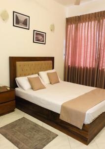 a bedroom with a large bed and a window at Luxurious Fully Furnished Apartment for Rent at 2000 Plaza, Colombo in Sri Jayewardenepura Kotte