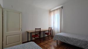 a room with a table and two chairs and a window at Altana Rooms in Koper