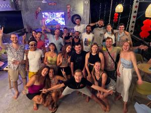 a group of people posing for a picture at a party at Wonderland Jungle Hostel in Koh Tao