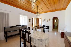 a dining room with a table and chairs at Villa Magdalini in Halki
