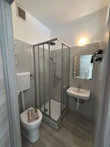 a bathroom with a shower and a toilet and a sink at Capri B&B in Bolzano