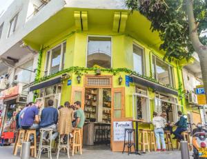 a group of people sitting in front of a building at Spacious New 1BD Levinski Florentin in Tel Aviv