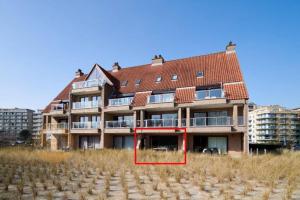 a large building with a red frame in front of it at 4-persoons appartement met een mooi uitzicht in De Panne