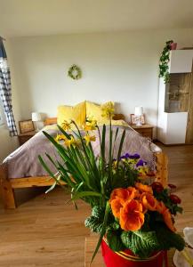 a bedroom with a bed with a bouquet of flowers at Apartment Sunset am Wolfgangsee in Strobl