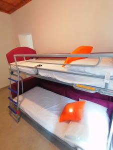 a room with three bunk beds in a room at Casa del Cigno in Monterotondo