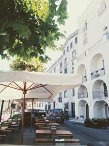 a group of tables and umbrellas in front of a building at affittacamere prezioso in Gaeta