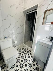 a white bathroom with a toilet and a sink at 4 Beds 3 Bath (2-ensuites) Free Parking 75Mbps in Stoke on Trent