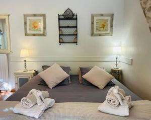 a bedroom with a bed with towels on it at Les Gîtes et la Chambre de Labahou SPA in Anduze +76 photos