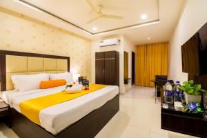 a hotel room with a large bed and a television at Hotel Fortune Hyderabad Airport Zone in Hyderabad