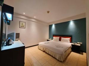 a hotel room with a bed and a television at Desa Phuket in Phuket Town +77 photos