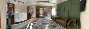 a living room with a couch and a green wall at Aral in Nukus