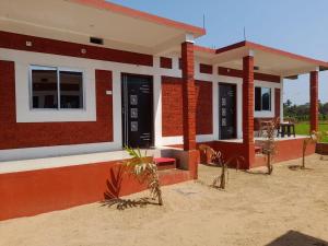 Sun Kissed Beach Stay في جوكارنا: بيت صغير فيه احمر وبيض