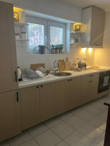 a kitchen with white cabinets and a sink at Villa Lena in Ohrid