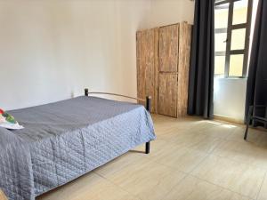 a bedroom with a bed and a wooden door at Beach front apartment in Grand Gaube