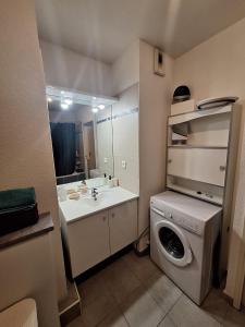 a bathroom with a washing machine and a sink at Appartement T2 à Montpellier in Montpellier