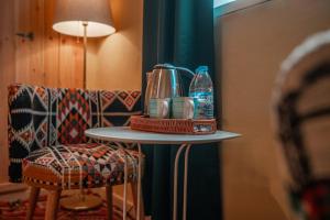 a table with a blender on it next to a chair at Jordan Heritage Madhafa in Al Salt