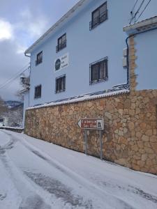 a building with a sign in front of it at HOSTAL SAN ANTONIO in Tragacete