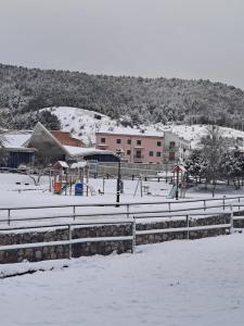 a park covered in snow with a playground at HOSTAL SAN ANTONIO in Tragacete