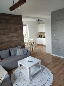 a living room with a couch and a table at Ustronny Zakątek in Ustroń