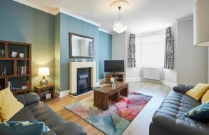 a living room with a couch and a fireplace at Pass the Keys Modern home in a seaside town in Seaham