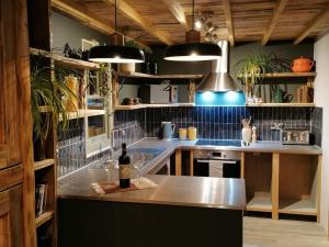 a kitchen with a counter with a bottle of wine at Stone Moor Lodge: Justin's Peak District Base Camp in Stocksbridge