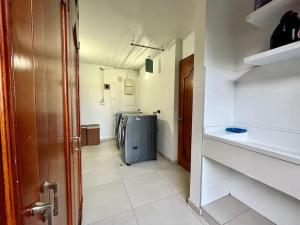 a bathroom with a sink and a washing machine at The Abbey - Country House in Cota +22 photos