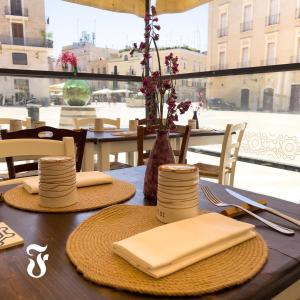 a table with plates and napkins on top of it at Bari Holiday Garibaldi 74 in Bari