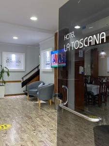 a hotel la costanza lobby with a piano and chairs at Hotel La Toscana in Villa Carlos Paz
