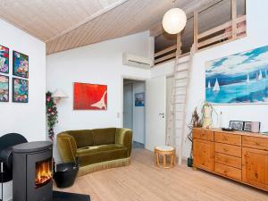 a living room with a couch and a fireplace at 6 person holiday home in Glesborg in Glesborg