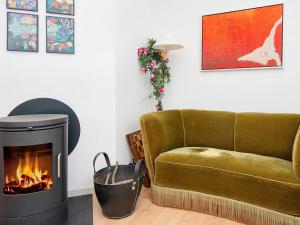 salon z kanapą i kominkiem w obiekcie 6 person holiday home in Glesborg w mieście Glesborg