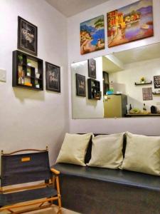 a living room with a couch and a mirror at C&C Cool View Tagaytay Staycation in Tagaytay