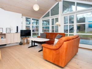 a living room with a couch and a table at 6 person holiday home in Glesborg in Glesborg